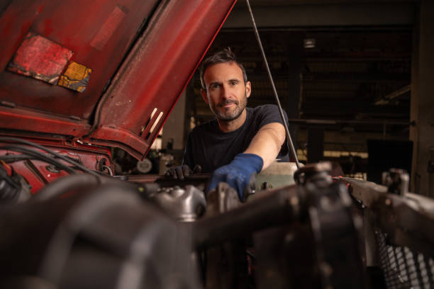 istock Mechanic repairs vehicle in shop 2148253424