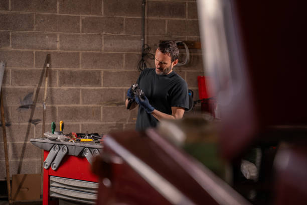 istock Man chooses tools for car repair in garage 2148253583