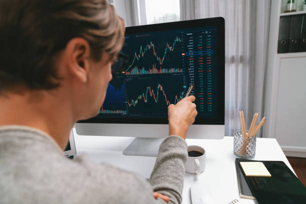 istock Investors pointing interesting stock exchange on pc with laptop. Pecuniary. 2148254214