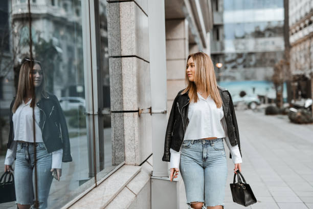 istock Female Admiring Her Own Stylishness In Building Window 2148254890