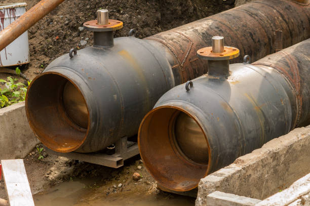istock Two black pipes with a rusty top and a metal ring 2148255120