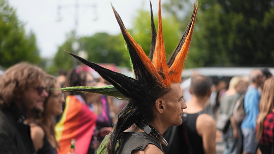 Cool punk rocker dyed mohawk hairstyle. Dressed up hipster enjoy hard rock music fest. Fun male carnival retro hair style. Fan stylish haircut. Queer lgbt pride party. Joyful gay person walk csd day.