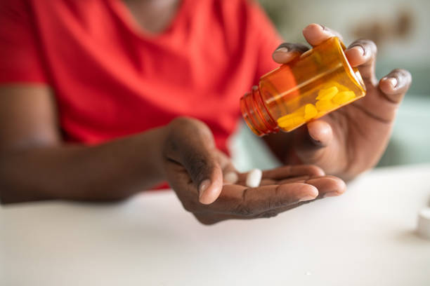 istock Young man taking medicine at home 2148255421