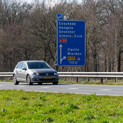 Netherlands, Overijssel, Twente, Wierden, March 19th 2023, side/front view close-up of a Dutch gray 2013 Volkswagen 7th generation Golf station wagon driving on the N36 at Wierden, the Golf has been made by German manufacturer Volkswagen since 1974, the N36 is a 36 kilometer long highway from Wierden to Ommen