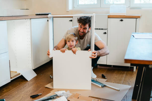 Father and son assembling kitchen furniture
