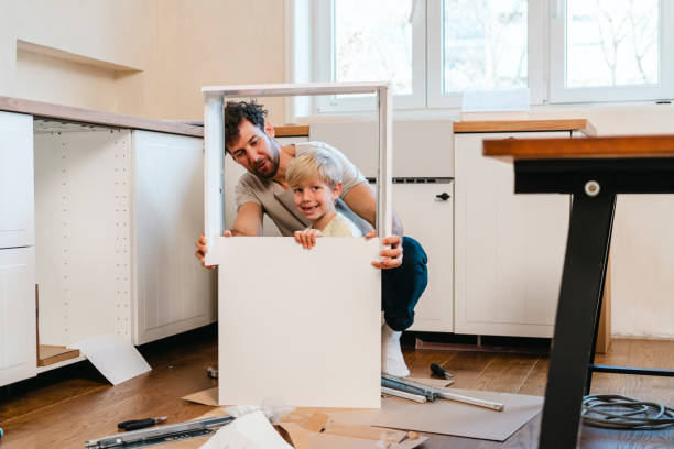istock Father and son assembling kitchen furniture 2148255996