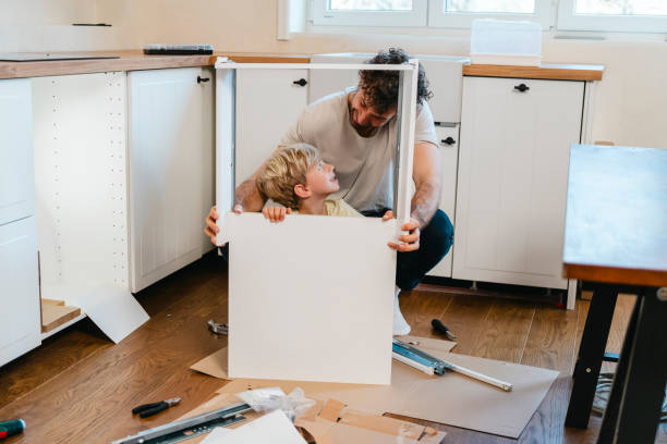 istock Father and son assembling kitchen furniture 2148256005