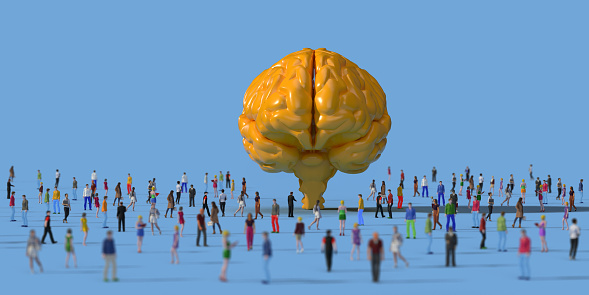 Human crowd surrounding a yellow brain model: Leadership Concept. Large group of 3D rendering people on coloured background side view, bird's eye view. Horizontal composition with copy space.