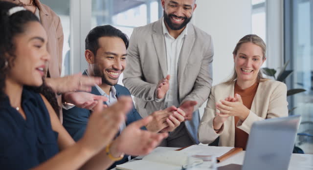 Business people, laptop and celebration or clapping for success, profit or sales and group achievement in office. Professional employees in applause, teamwork and congratulations on computer for news