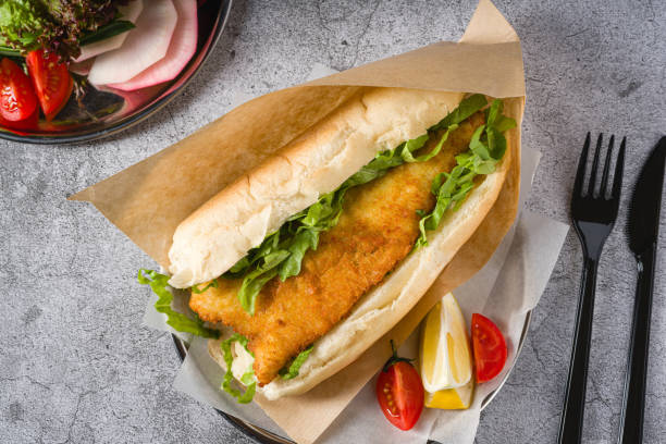 istock Fried fish sandwich with greens on the stone table. Turkish name Balik Ekmek 2148259920