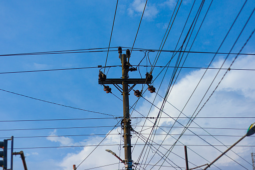 a high voltage electricity pole with many wires running across it