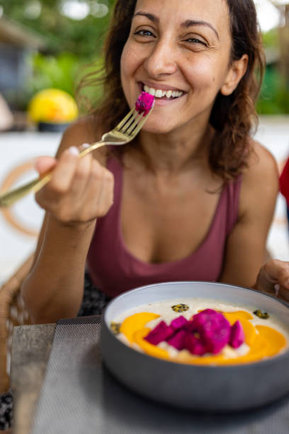 istock Woman enjoying a smoothie bowl 2148260561