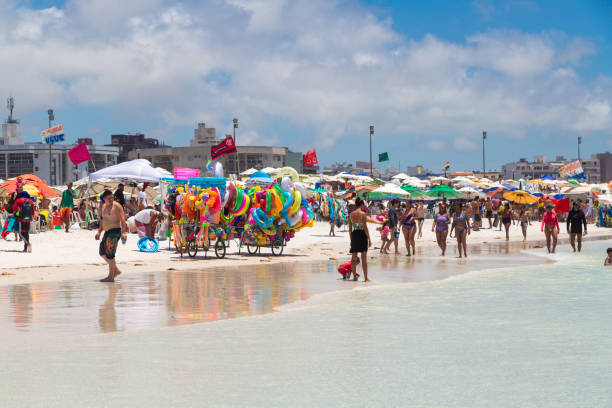 Cabo Frio, Rio de Janeiro, Brazil - December 26, 2019: Panoramic view of Praia do Forte beach in the town. White sand, clear and transparent water of sea. Many people enjoying of the sunny day.