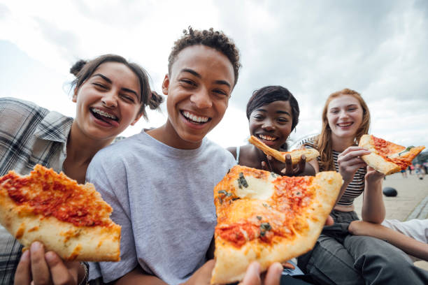 istock Friends Enjoying Food Together 2148261232