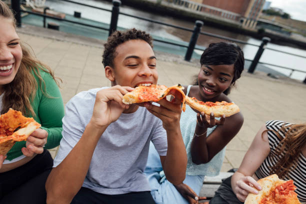 istock Tucking Into A Slice Of Pizza 2148261402