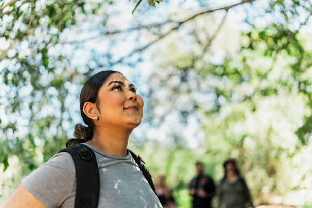 istock Young woman looking around hiking in forest 2148261479