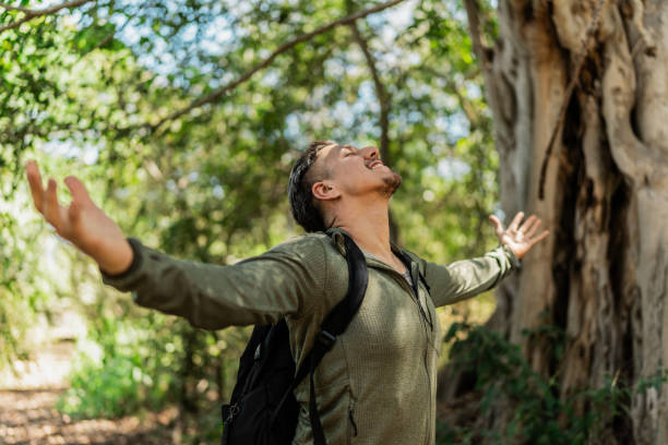 istock Mid adult man feeling grateful during hiking on forest 2148261480