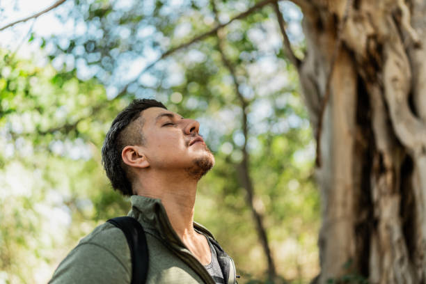 istock Mid adult man feeling grateful during hiking on forest 2148261486