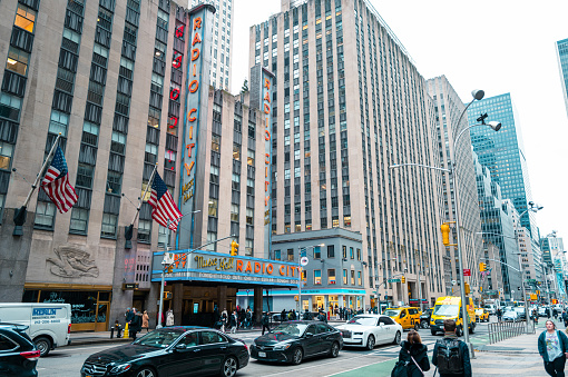 New York, United States of America - February 23, 2024: The image captures the renowned Radio City Music Hall in Manhattan amidst the bustling streets, and iconic landmarks, epitomizing the dynamic essence of New York City.