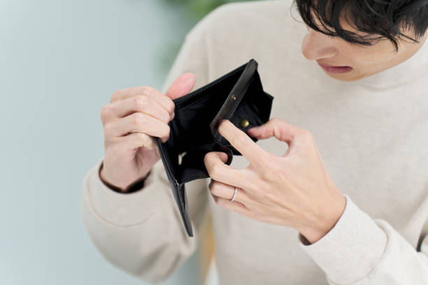 istock A man holding a wallet with no money in it 2148261989