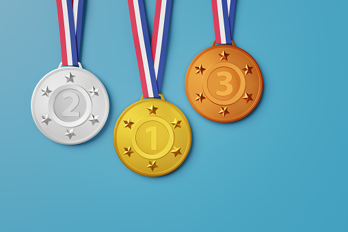 Gold, silver and bronze medals with a classic red, white and blue ribbon on light blue background. Illustration of the concept of competition, sports, winners, recognition and prizes