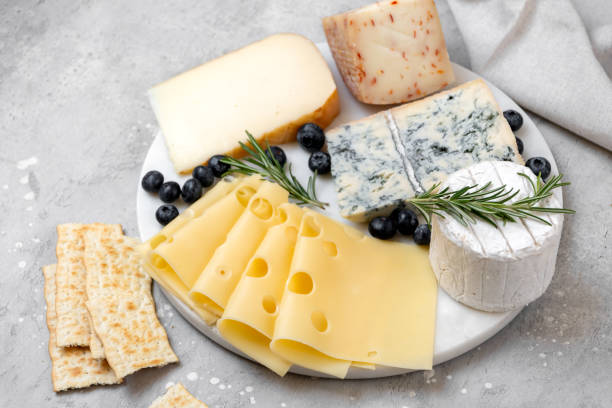 istock Cheese platter with craft cheese assortment on a marble platter. hard cheeses, mold cheese, gorgonzola, pecorino, Emmental, Roquefort 2148263941