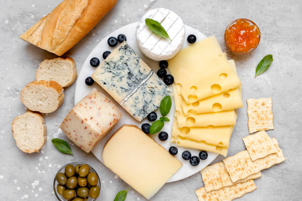 istock Cheese platter with craft cheese assortment on a marble platter. hard cheeses, mold cheese, gorgonzola, pecorino, Emmental, Roquefort 2148263954