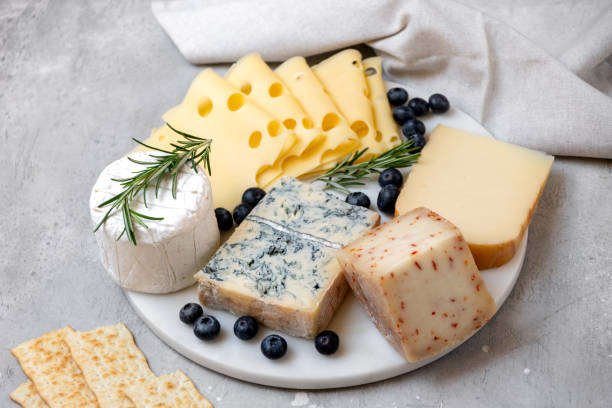 istock Cheese platter with craft cheese assortment on a marble platter. hard cheeses, mold cheese, gorgonzola, pecorino, Emmental, Roquefort 2148264001