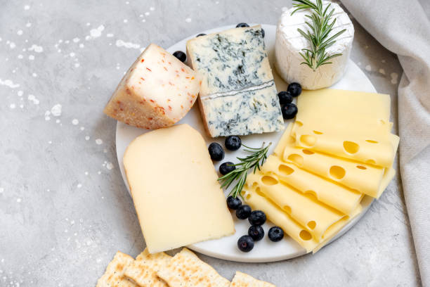 istock Cheese platter with craft cheese assortment on a marble platter. hard cheeses, mold cheese, gorgonzola, pecorino, Emmental, Roquefort 2148264043