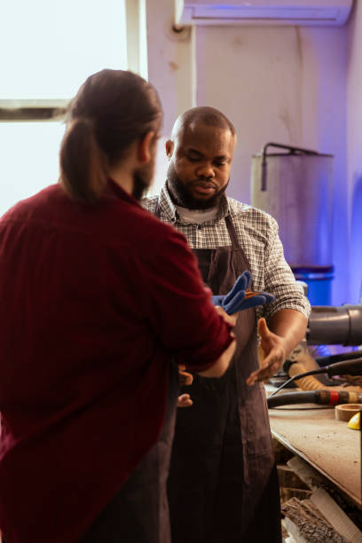 istock Master in shop giving worker protection gloves before assembling furniture 2148266706