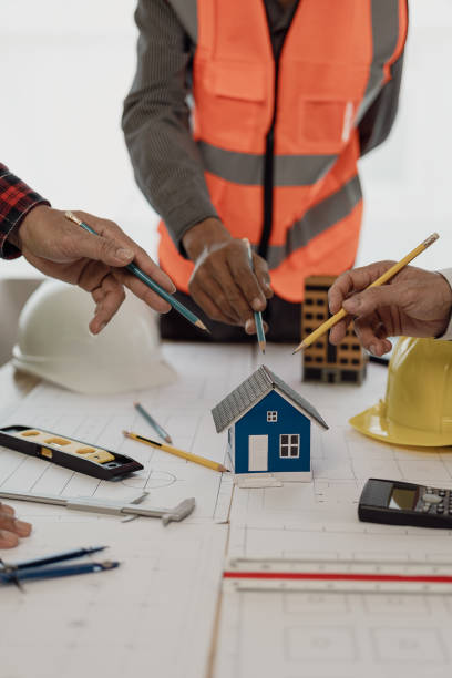 istock Pictures of architecture project engineer meeting Collaborate with partners and engineering tools and point at drawings to discuss. Engineering tools and construction concepts vertical picture 2148267500