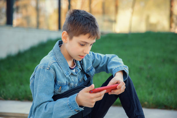 istock Boy enthusiastically playing on the phone 2148267604