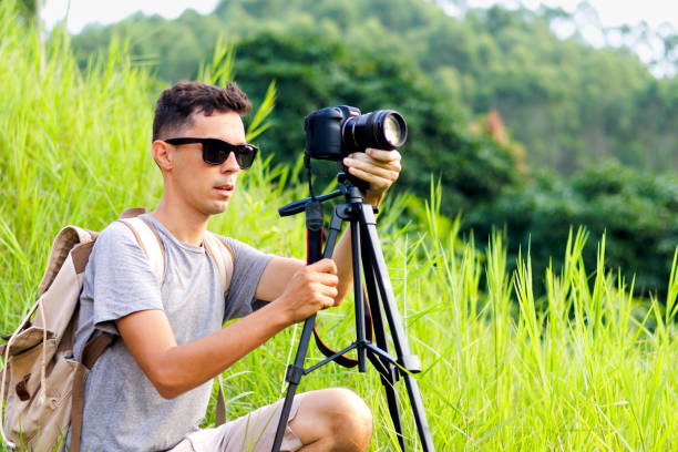 istock A man filming the sunset on a mountain. 2148267673