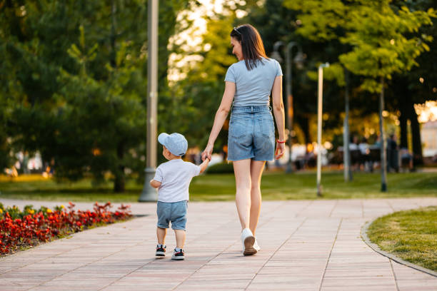 istock Young Mother Walking With Her Son In The Park 2148267765
