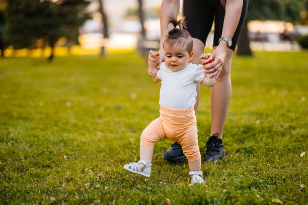 istock Young Mother Teaching Her Daughter How To Walk In The Park 2148267905