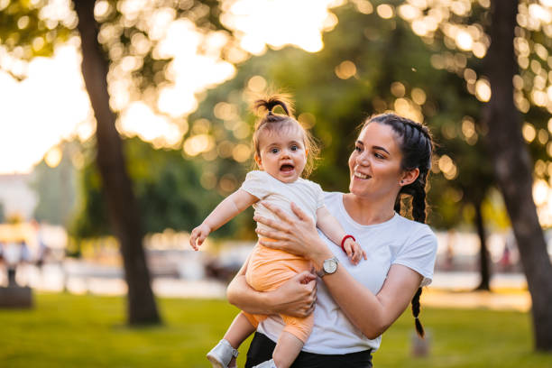 istock Young Mother Holding Her Daughter In The Park 2148267971