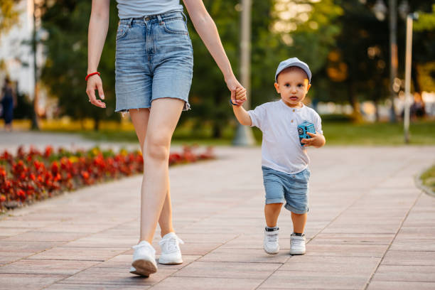 istock Young Mother Walking With Her Son In The Park 2148267985