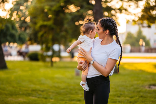 istock Young Mother Holding Her Daughter In The Park 2148268027