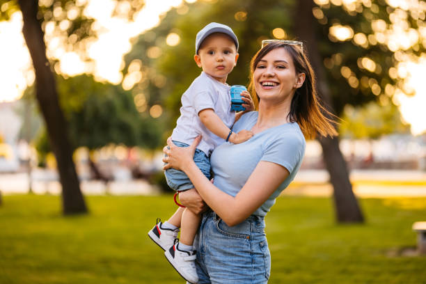 istock Young Mother Holding Her Son In The Park 2148268134