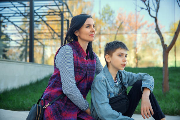 Mother and son sitting in the park