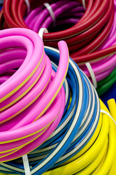 istock Rolled up colorful garden hose 2148270705