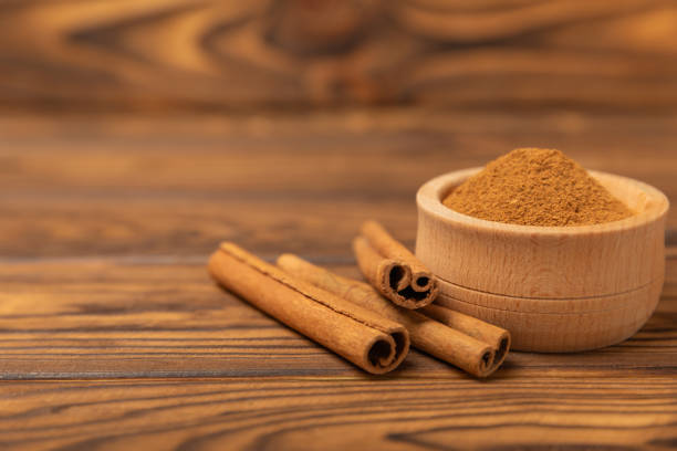 istock Cinnamon sticks on a textured wooden background. Cinnamon roll. Spicy spice for baking, desserts and drinks. Fragrant ground cinnamon. cinnamon powder Close-up. Place for text. copy space 2148272310