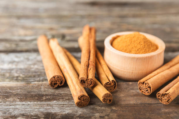 istock Ceylon cinnamon.Cinnamon sticks on a textured wooden background. Cinnamon roll and powder. Spicy spice for baking, desserts and drinks. Fragrant ground cinnamon. Close-up. Place for text. copy space 2148272352