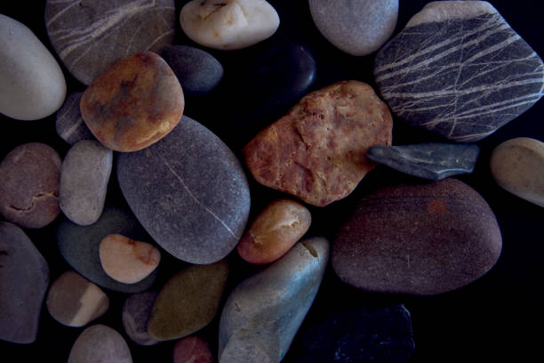 istock texture of sea pebbles on a black background 2148273900