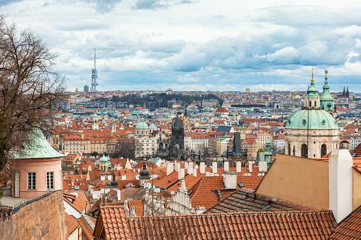 Panorama of old historic town Prague in Czech Praha, view from castle hill in sunny day, in front Church of Saint Nicholas. Central Bohemia, Czech Republic