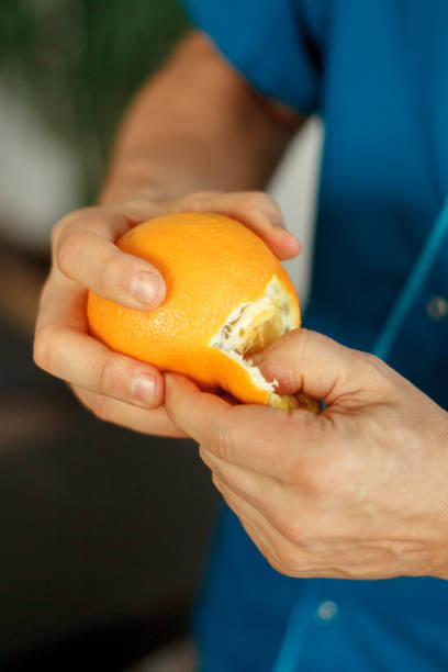 istock hands peeling orange peel and zest 2148275746