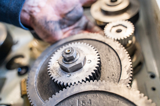 Detail of hands and gears in shop