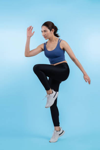 Side view young athletic asian woman on running posture. Vigorous