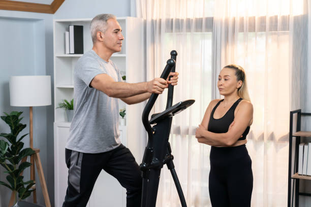 istock Active senior couple running on elliptical running machine. Clout 2148277005