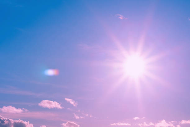 Beautiful pink,purple sunset cloudy sky evening.Landscape,sun sunrays through the white clouds.Toned.